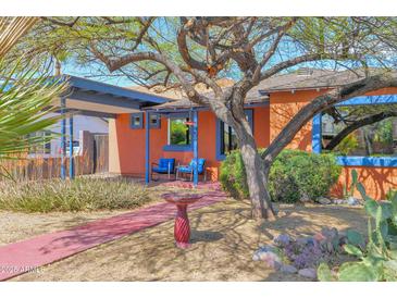 Charming home featuring a covered carport and colorful front patio and drought-tolerant landscaping at 1454 E Flower St, Phoenix, AZ 85014