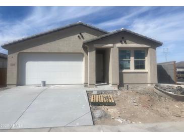 Charming single-story home with a spacious two-car garage and a well-manicured front lawn at 17216 W Sunward Dr, Goodyear, AZ 85338