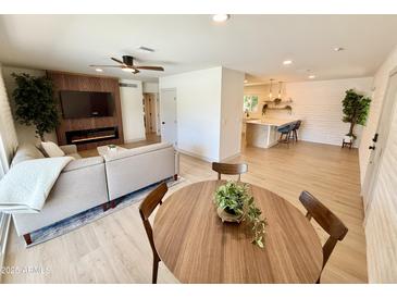 Open concept living area boasts a fireplace, modern lighting, and tile floors at 1901 E Missouri Ave # 220, Phoenix, AZ 85016
