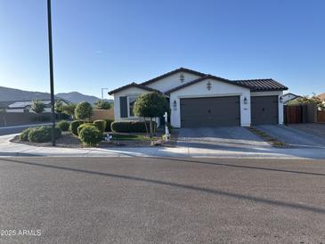 Inviting single Gathering home with a clean, modern elevation, a two-car garage, and desert landscaping at 19864 W San Juan Ave, Litchfield Park, AZ 85340