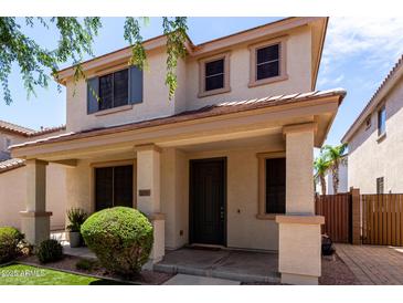 Charming two-story home with a welcoming front porch and well-maintained landscaping at 2116 S Moccasin Trl, Gilbert, AZ 85295