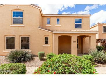 Charming tan two-story home with arched entry and landscaped front yard at 3507 E Erie St, Gilbert, AZ 85295