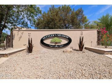 Settler's Meadow community sign with a green tree logo and decorative metal accents at 493 E Baylor Ln, Gilbert, AZ 85296