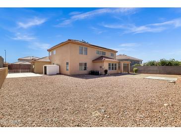 Large backyard with low maintenance stone landscaping, shed and mature trees at 10520 W Patrick Ln, Peoria, AZ 85383