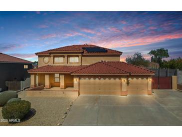 Charming two-story home with a terracotta roof, three-car garage, and well-maintained landscaping at 10520 W Patrick Ln, Peoria, AZ 85383