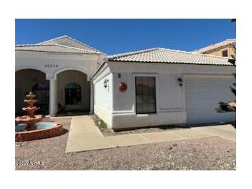 Charming home featuring a well-manicured yard, decorative fountain, and white exterior at 14240 N Ibsen Dr # B, Fountain Hills, AZ 85268