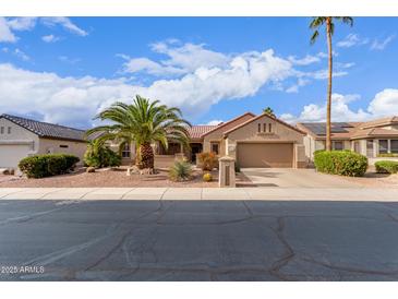 Charming single-story home with a well-maintained yard, desert landscaping, and a spacious driveway at 15850 W Silver Breeze Dr, Surprise, AZ 85374