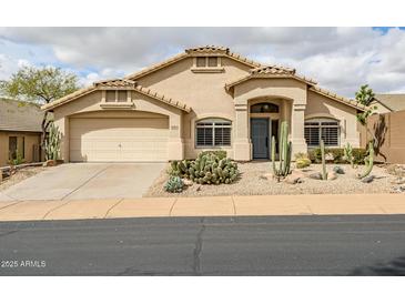 Charming single-story home with desert landscaping and a two-car garage at 16388 N 99Th Pl, Scottsdale, AZ 85260