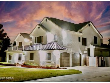 An inviting two-story home with a well-manicured lawn and a two-car garage offering curb appeal at 19450 E Silver Creek Ln, Queen Creek, AZ 85142