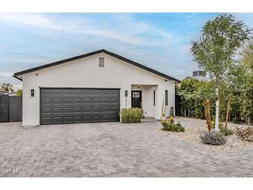 Charming home features a modern design, updated landscaping, and a spacious driveway at 2022 N 22Nd Pl, Phoenix, AZ 85006