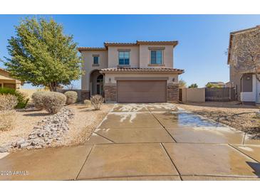 Inviting two-story home featuring a two-car garage, neutral stucco facade, and low-maintenance landscaping at 599 W Agrarian Hills Dr, San Tan Valley, AZ 85143