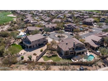 Expansive aerial view of the community with golf course, putting green, and tile-roofed homes at 7418 E Sandia Cir, Mesa, AZ 85207