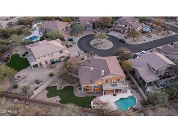 Beautiful aerial view of the home featuring an outdoor pool, patio and fire pit in a desert landscape at 7418 E Sandia Cir, Mesa, AZ 85207