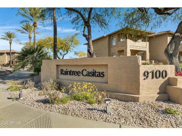 Attractive Raintree Casitas community sign with desert landscaping and palm trees at 9100 E Raintree Dr # 209, Scottsdale, AZ 85260