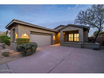 Charming single-story home featuring a well-manicured front yard and a spacious two-car garage at 9435 E Mohawk Ln, Scottsdale, AZ 85255