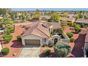 Beautiful home featuring a barrel tile roof, two car garage, and desert landscaping at 12915 W Micheltorena Dr, Sun City West, AZ 85375