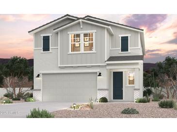 Charming two-story home boasting a stylish gray color scheme, complementary landscaping, and a convenient attached garage at 17248 W Daley Ln, Surprise, AZ 85387