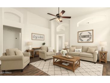 Bright living room with vaulted ceilings, ceiling fan, stylish decor and comfortable seating at 2025 N 106Th Dr, Avondale, AZ 85392