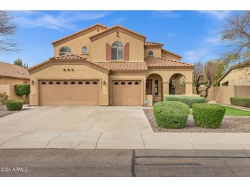 Expansive two-story home featuring a three-car garage, desert landscaping, and a beautiful neutral color palette at 2280 E Aloe Pl, Chandler, AZ 85286