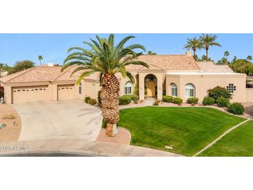 Beautiful single story home with manicured lawn, desert landscaping, and a spacious driveway at 11216 E Appaloosa Pl, Scottsdale, AZ 85259