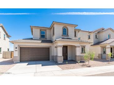 Charming two-story home featuring a covered entryway, neutral stucco, and a two-car garage at 1193 E Spruce Dr, Chandler, AZ 85286