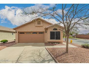 Charming single-story home with a two-car garage and low maintenance landscaping at 121 N Ramada --, Mesa, AZ 85205