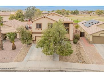 Charming two-story home with a well-manicured front yard and a tile roof at 14450 N 132Nd Dr, Surprise, AZ 85379