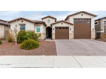 Beautiful single-Gathering home featuring a desert landscape, a two-car garage and stylish architecture at 17810 W Straight Arrow Ln, Surprise, AZ 85387