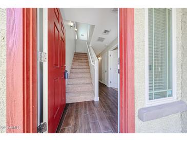 Inviting entryway with wood-look tile flooring and a staircase leading to the upper level at 2150 W Alameda Rd # 1122, Phoenix, AZ 85085