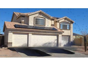 Two-story home with a three-car garage and solar panels on the roof at 22016 W Loma Linda Blvd, Buckeye, AZ 85326