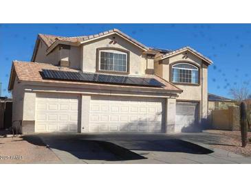 Charming two-story home with a three car garage and solar panels on the roof at 22016 W Loma Linda Blvd, Buckeye, AZ 85326