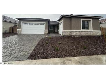 Inviting single-story home with a two-car garage and manicured landscaping at 24116 N 172Nd Ave, Surprise, AZ 85387