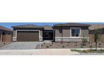 Charming single-story home with a two-car garage, stone accents, and a well-maintained front yard at 24116 N 172Nd Ave, Surprise, AZ 85387