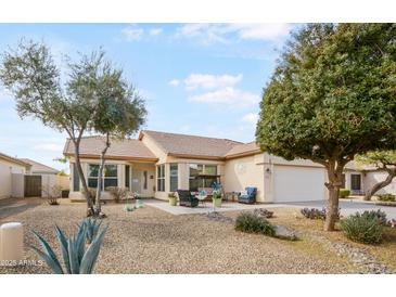 Charming single-story home featuring desert landscaping and a welcoming front patio with seating area at 3089 E Hazeltine Way, Chandler, AZ 85249