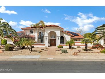 Beautiful single-Gathering home featuring stucco siding, terra cotta roof, mature landscaping, and a brick walkway at 3522 E Fountain St, Mesa, AZ 85213