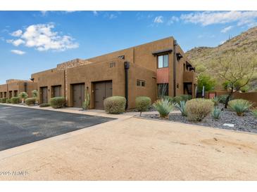 Contemporary two-story townhome featuring an attached two-car garage and desert landscaping, close to local mountain at 36600 N Cave Creek Rd # C17, Cave Creek, AZ 85331