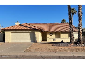 Charming single-story home with a tile roof, a two-car garage and a desert style front yard at 4330 E Beck Ln, Phoenix, AZ 85032