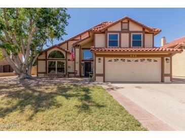 Charming two-story home with a red tile roof, large shade tree and a two-car garage at 956 N 58Th St, Mesa, AZ 85205