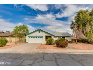 Charming single-story home features a well-manicured front yard and attached two-car garage at 962 E Greenway St, Mesa, AZ 85203