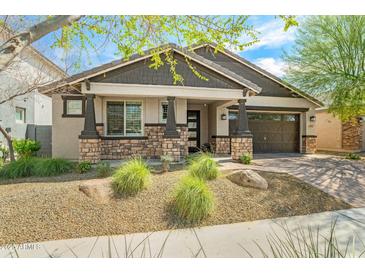 Charming single-story home with stone accents, a desert landscaped yard, and a two-car garage at 25511 S 227Th St, Queen Creek, AZ 85142