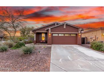 Charming single-story home featuring a well-manicured front yard and a two-car garage at 31062 N 136Th Ln, Peoria, AZ 85383