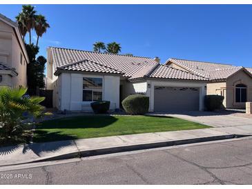 Charming single-story home featuring a well-manicured lawn and a lovely tiled roof at 4751 E White Aster St, Phoenix, AZ 85044