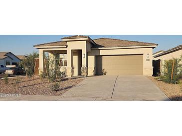 Inviting single-story home with a neutral palette, low-maintenance landscaping, and an attached two-car garage at 4919 S 106Th Ave, Tolleson, AZ 85353