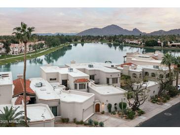 Beautiful waterfront home featuring desert landscaping and a view of Camelback mountain at 8369 E Del Camino Dr, Scottsdale, AZ 85258