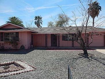 Charming single-story home with a well-kept desert landscaped front yard and rock at 10319 W Willie Low Cir, Sun City, AZ 85351