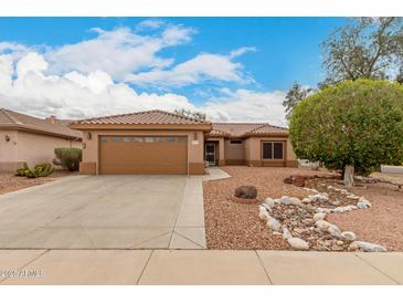 Charming single-story home showcasing a well-manicured desert landscape and a two-car garage at 15026 W Cactus Ridge Way, Surprise, AZ 85374