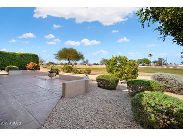 Relaxing outdoor patio featuring beautiful landscaping and golf course view at 15560 W Clear Canyon Dr, Surprise, AZ 85374