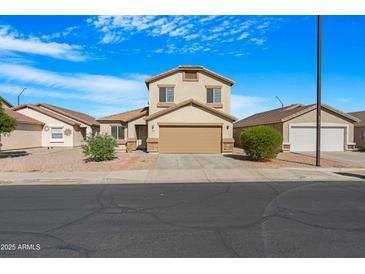 Charming two-story home featuring a neutral-colored exterior, well-kept landscaping, and a two-car garage at 1563 S 227Th Ave, Buckeye, AZ 85326