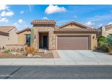 Charming single-story home with a well-manicured front yard and attached two-car garage at 26336 W Tina Ln, Buckeye, AZ 85396