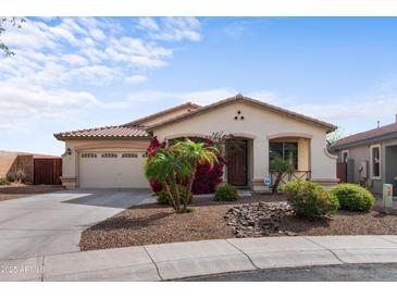 Charming single-story home features a two-car garage and desert landscaping at 3253 N 138Th Ave, Avondale, AZ 85392